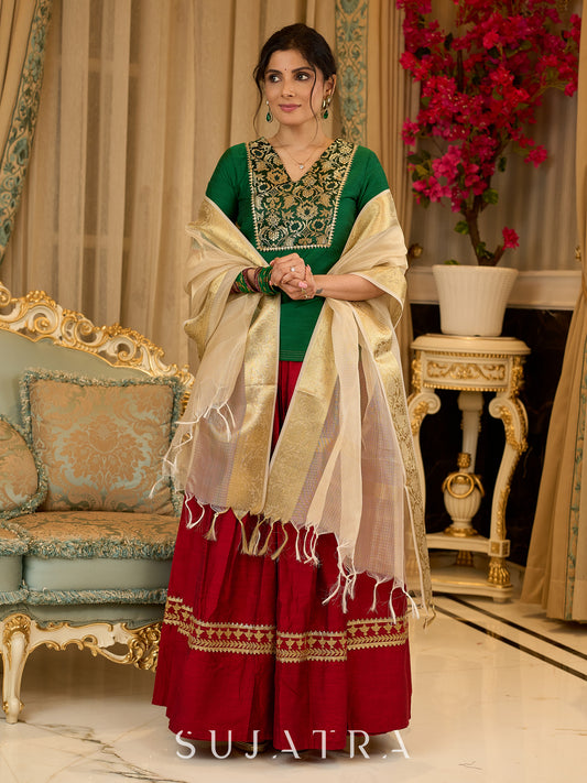 A traditional look featuring a red Cotton silk lehenga with a green Cotton silk choli with brocade yoke  - Contrast dupatta optional
