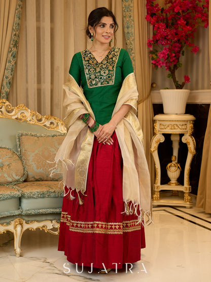 A traditional look featuring a red Cotton silk lehenga with a green Cotton silk choli with brocade yoke  - Contrast dupatta optional