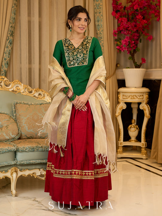 A traditional look featuring a red Cotton silk lehenga with a green Cotton silk choli with brocade yoke  - Contrast dupatta optional