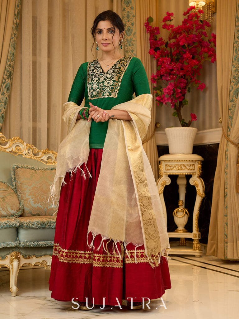 A traditional look featuring a red Cotton silk lehenga with a green Cotton silk choli with brocade yoke  - Contrast dupatta optional