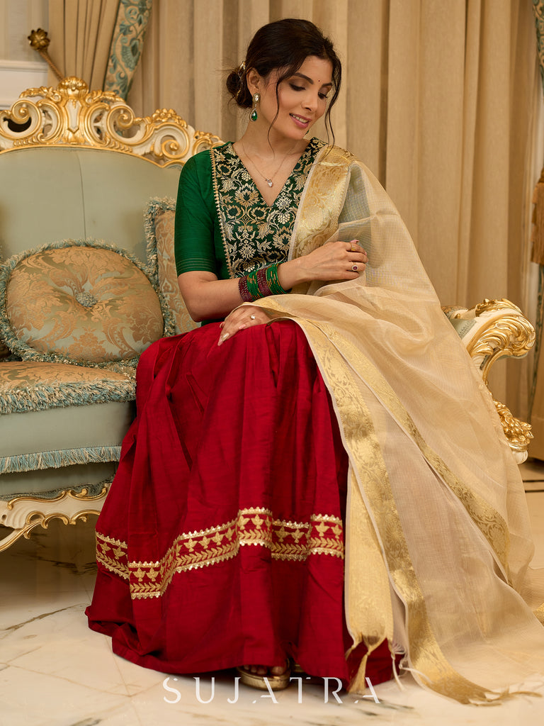 A traditional look featuring a red Cotton silk lehenga with a green Cotton silk choli with brocade yoke  - Contrast dupatta optional