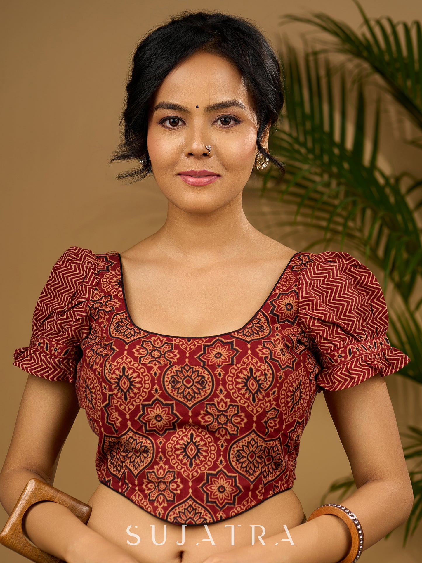 Sleek corset -style ajrakh fitted silhouette cotton blouse .