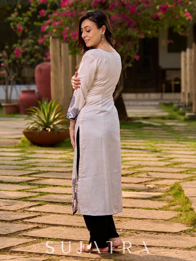 Artisanal cream kurta showcasing Madhubani fish and peacock motifs enhanced with bold black accents