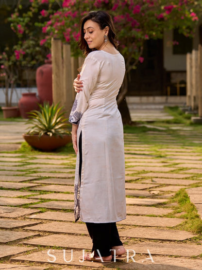 Artisanal cream kurta showcasing Madhubani fish and peacock motifs enhanced with bold black accents