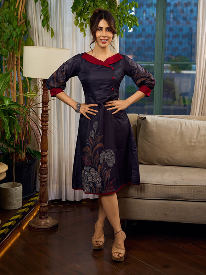 Elegant black Kalamkari-inspired dress with deep maroon accents and graceful floral motifs.