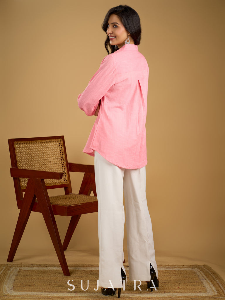 Delicate hand painting enhances this baby pink collared cotton top