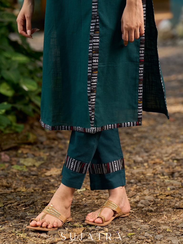 bottle green solid kurta with a refined ajrakh edging.