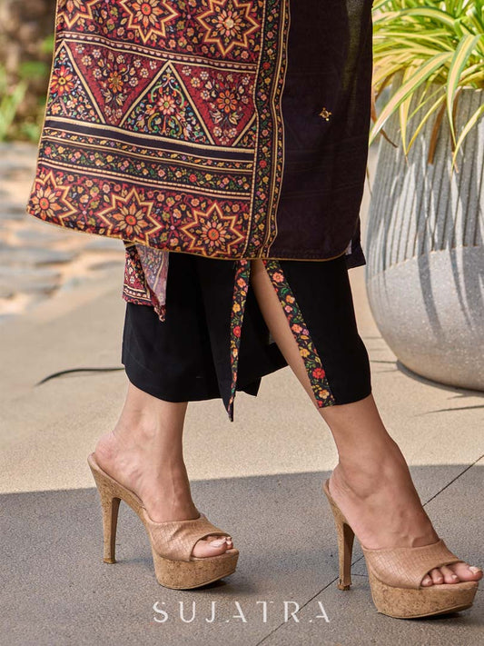 Chic black rayon pants featuring a graceful slit and intricate border detailing.