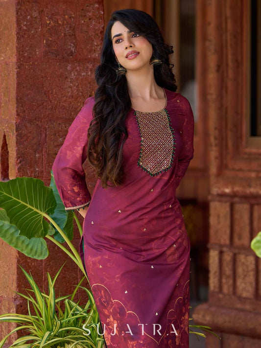 Exquisite deep burgundy printed kurta with intricate neck panel embroidery, delicate green beads, and refined green highlights.