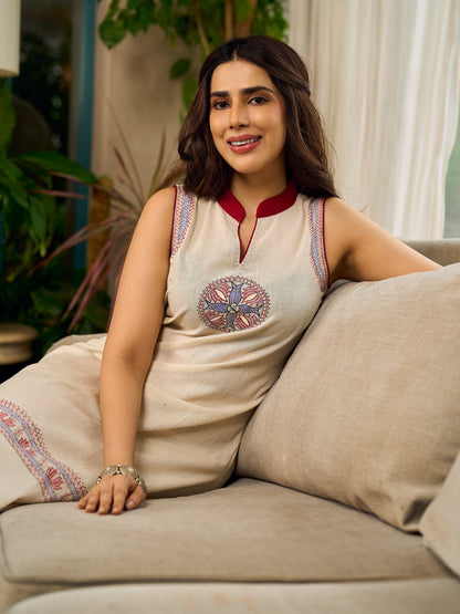 Off-white dress featuring intricate Madhubani artwork and a maroon Mandarin collar.