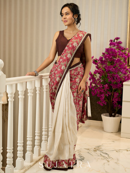 Ivory elegance meets rich pink florals in this exclusive cotton saree