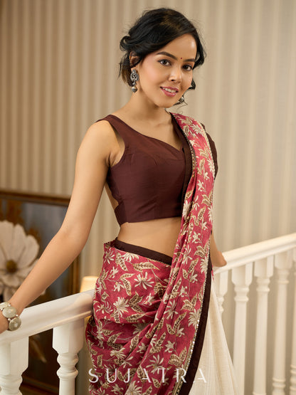 Ivory elegance meets rich pink florals in this exclusive cotton saree