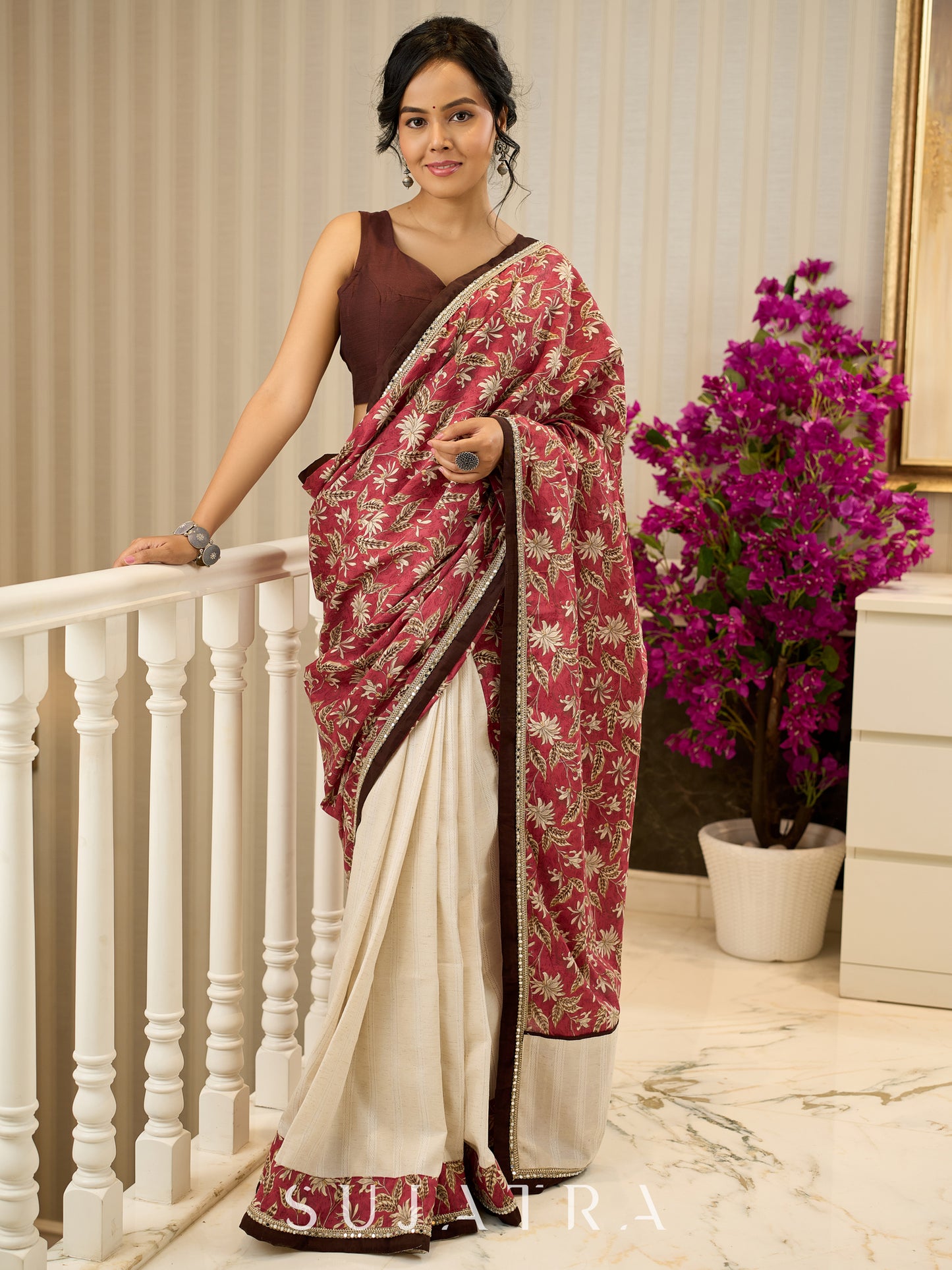Ivory elegance meets rich pink florals in this exclusive cotton saree