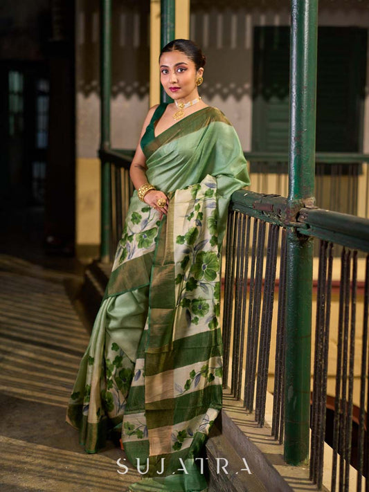Muted Green Tussar Silk Saree with Delicate Floral Artwork and Classic Border