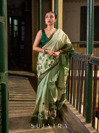 Muted Green Tussar Silk Saree with Delicate Floral Artwork and Classic Border