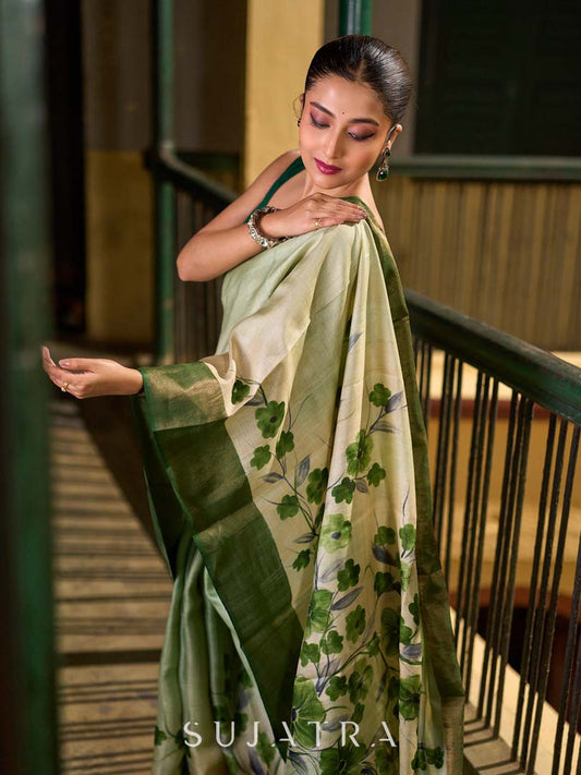 Muted Green Tussar Silk Saree with Delicate Floral Artwork and Classic Border
