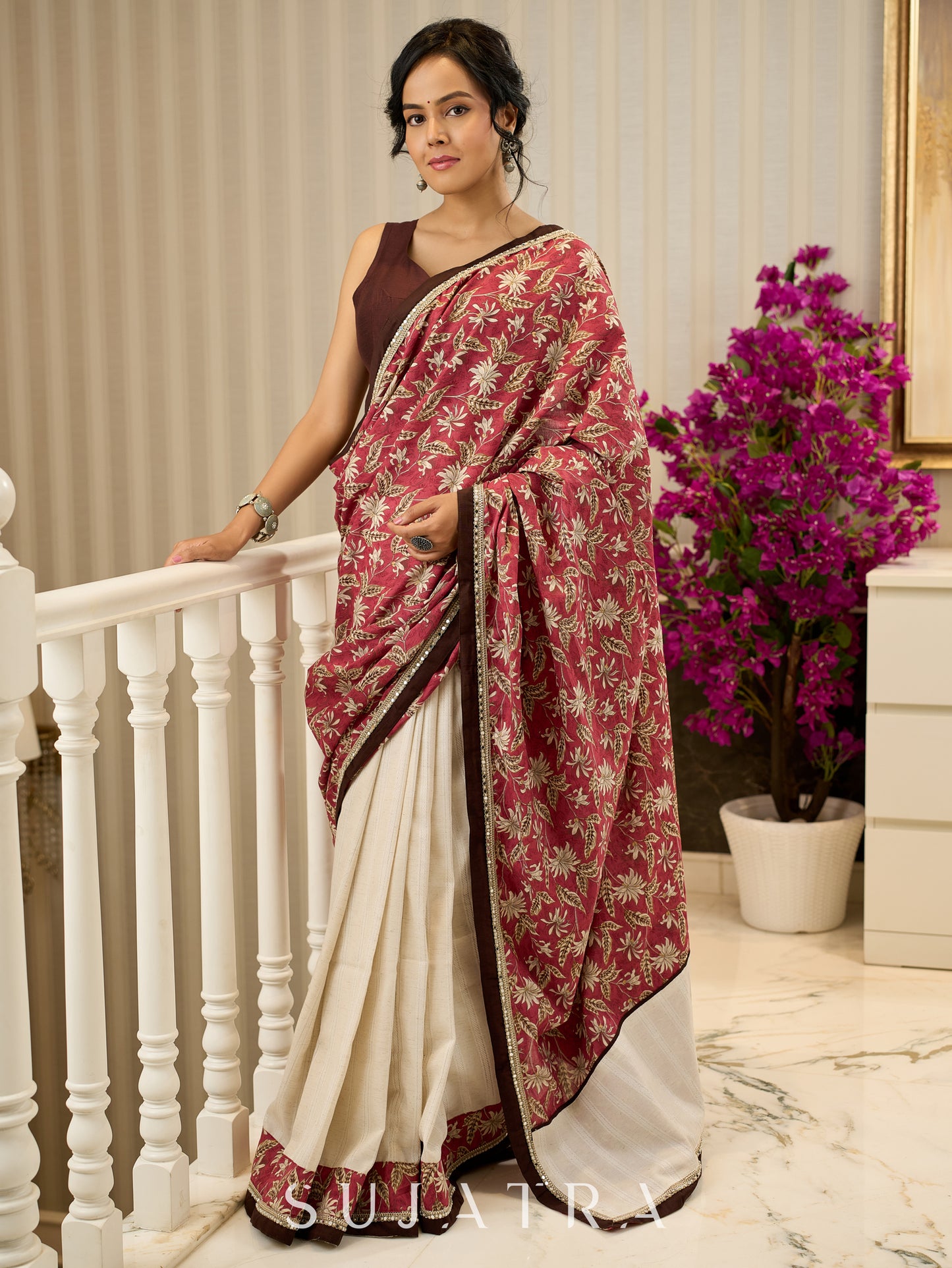 Ivory elegance meets rich pink florals in this exclusive cotton saree