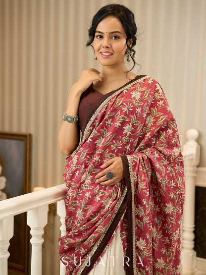 Ivory elegance meets rich pink florals in this exclusive cotton saree