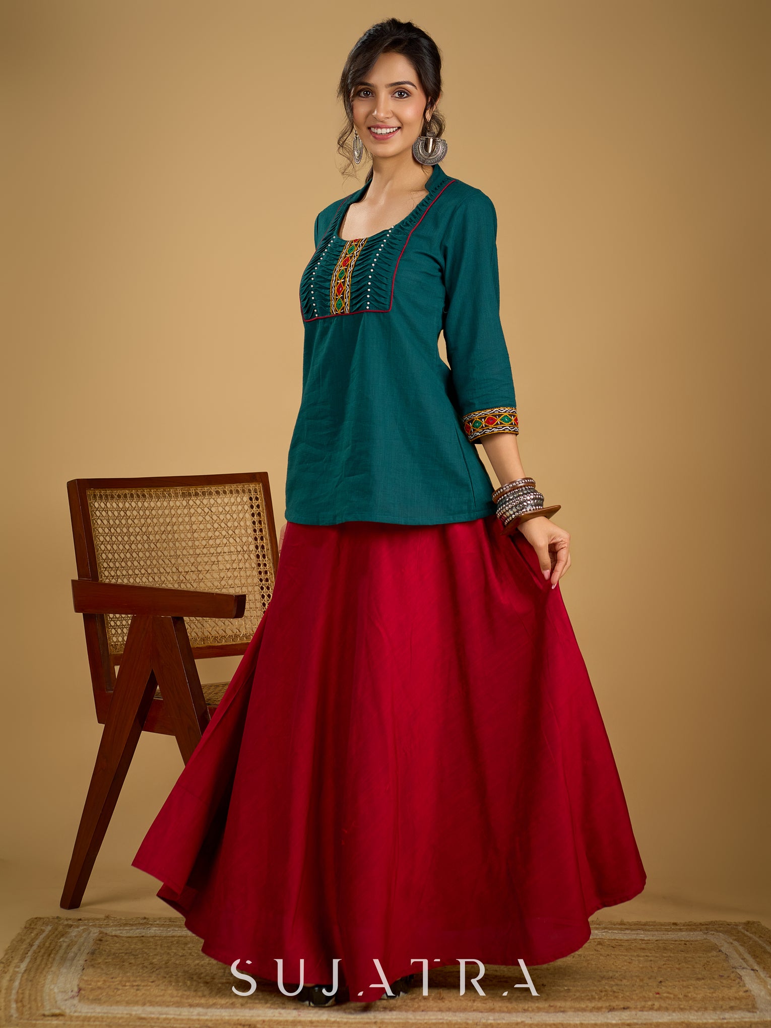 Stylish dark green cotton top with pleats,mirror,and pearl work