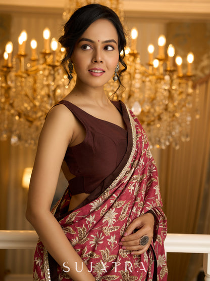 Ivory elegance meets rich pink florals in this exclusive cotton saree