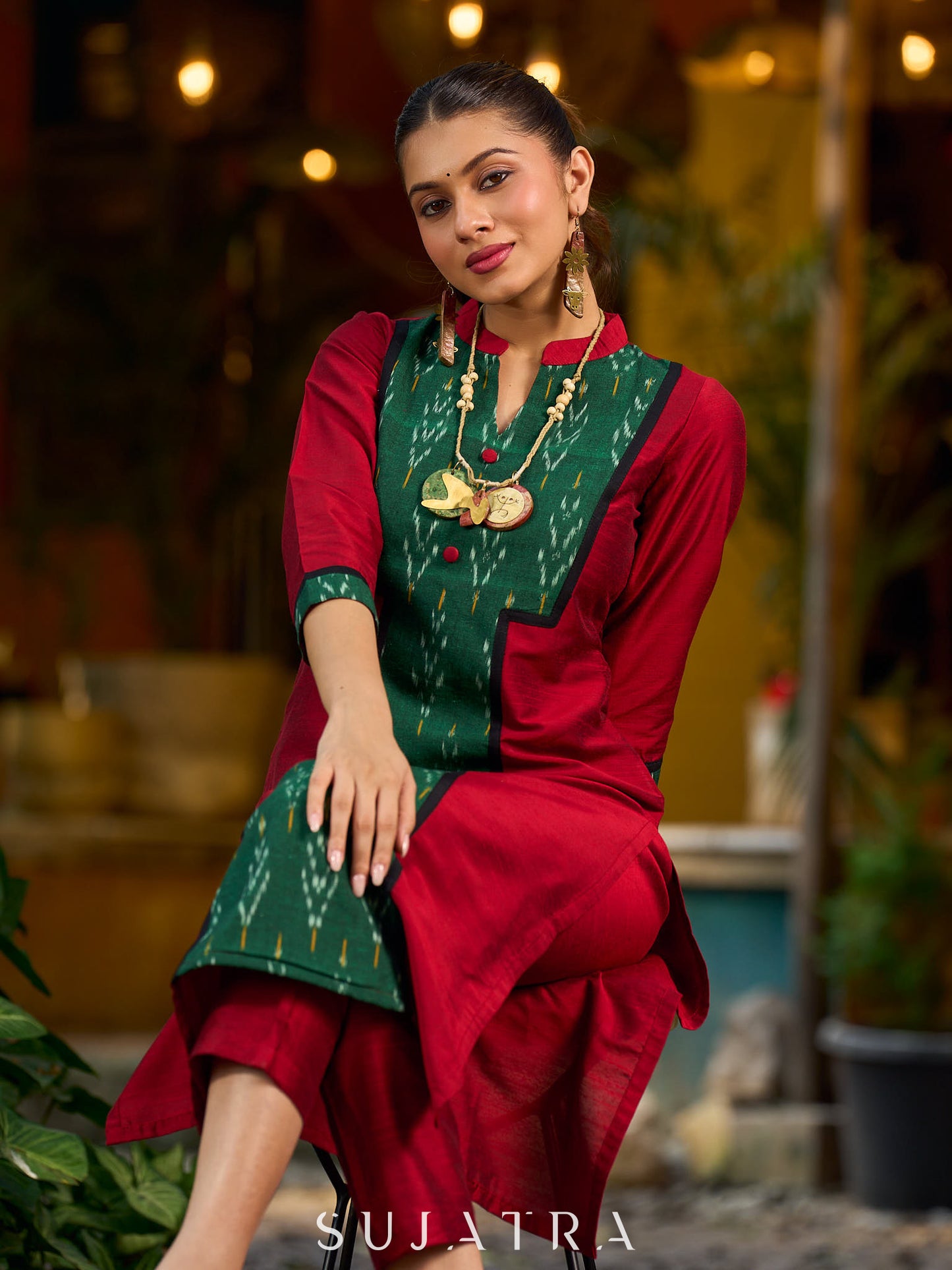 Elegant maroon cotton-silk kurta featuring a green Ikat patch and stand collar.