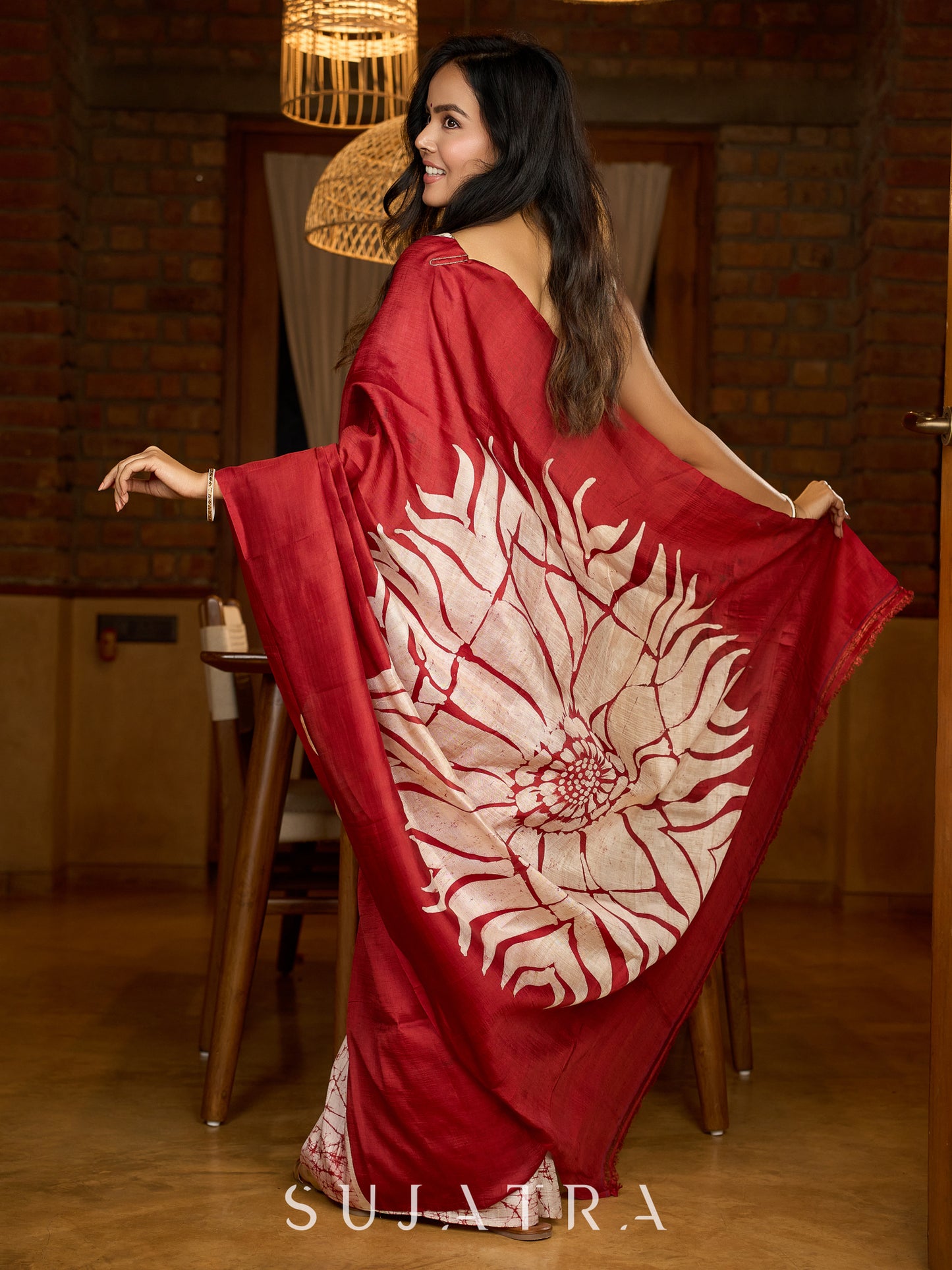 Artisanal crimson silk saree featuring heritage batik floral designs