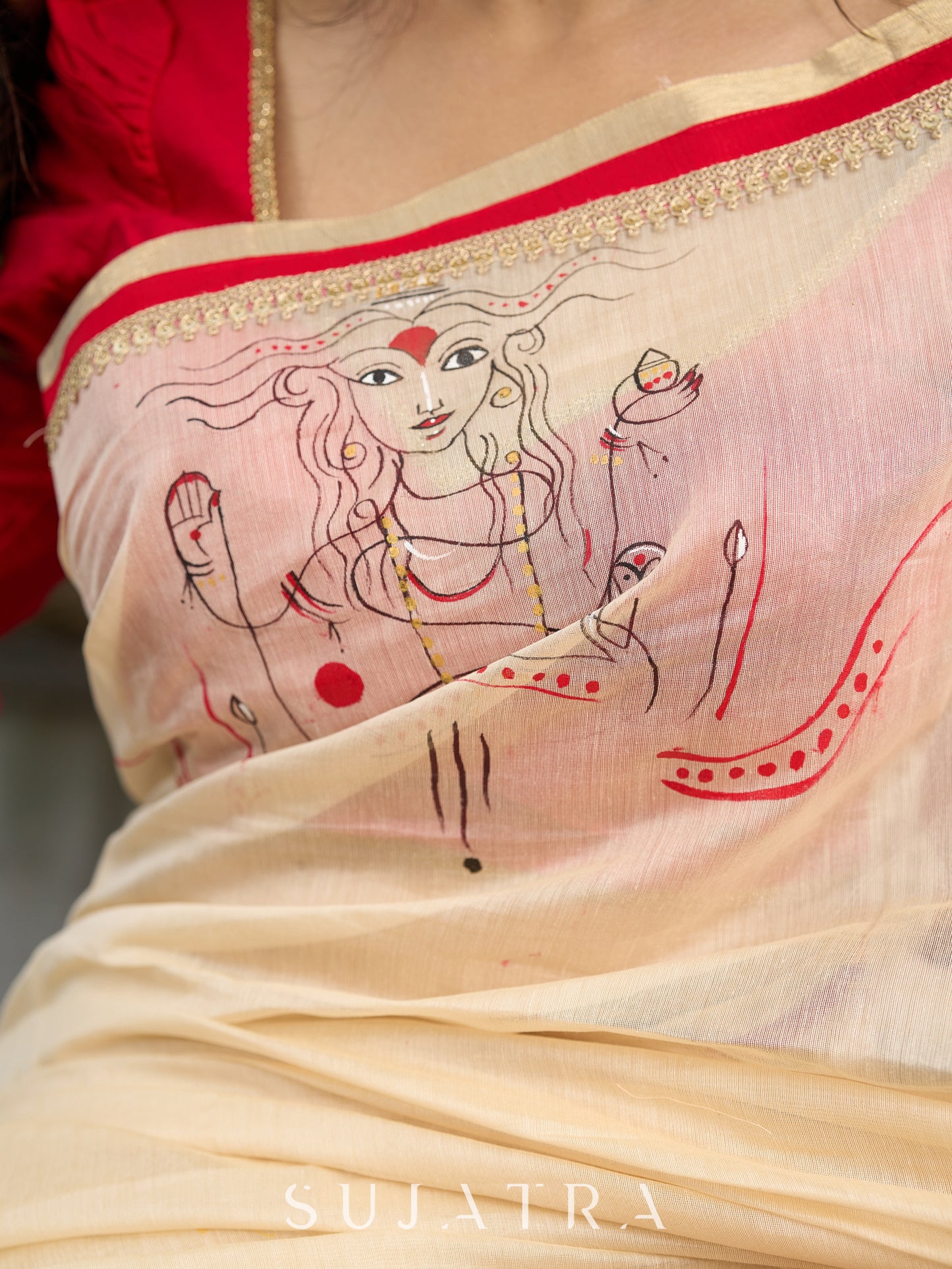 Elegant cream chanderi saree with subtle red border, featuring hand-painted Durga art