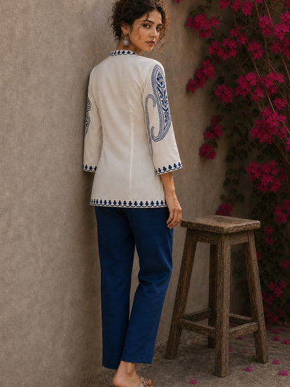 Elegant ivory hand block print top featuring intricate navy blue paisley sleeves, refined contrast detailing, and graceful pintucks, blending artisanal craftsmanship with timeless everyday sophistication.