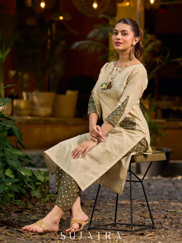 timeless cream kurta enhanced with handcrafted olive bandhani elements.