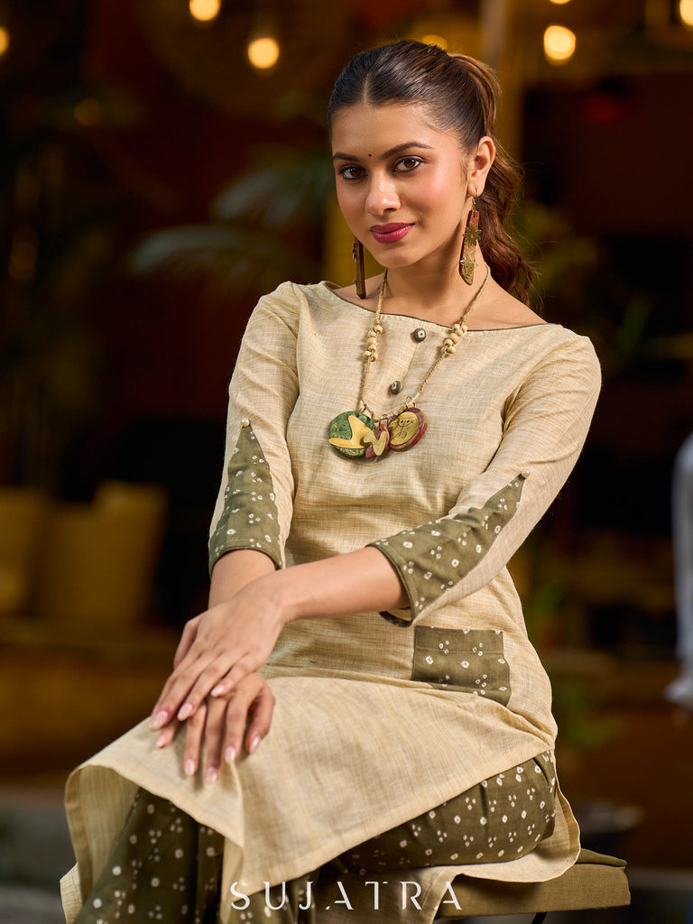 timeless cream kurta enhanced with handcrafted olive bandhani elements.