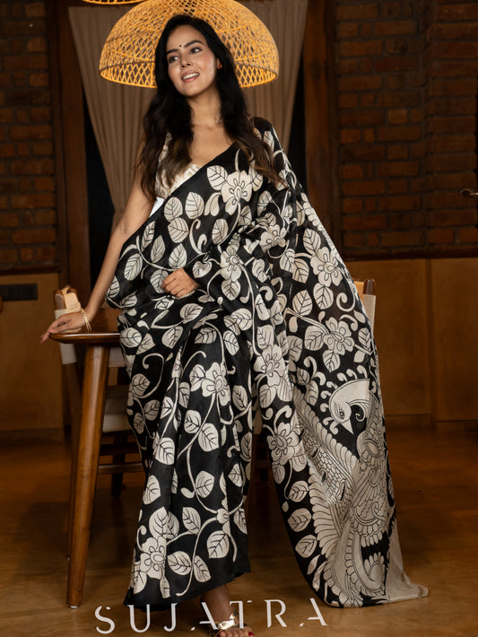 Artisanal black silk saree featuring intricate hand-drawn Kalamkari style motifs