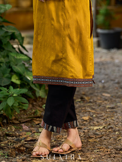 Chic solid black pants with timeless Ikat Border