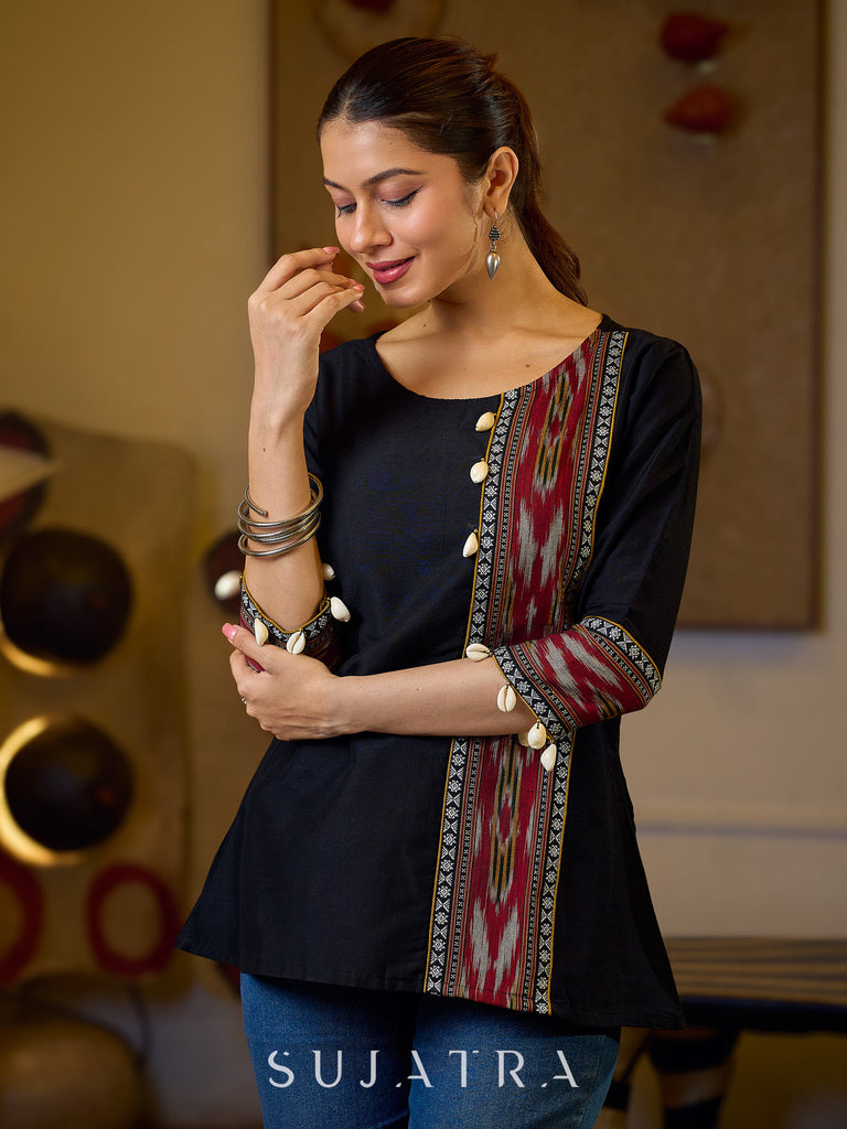 Sleek Black Cotton Silk Top Adorned with Ikat Borders and Exquisite Cowrie Embellishments