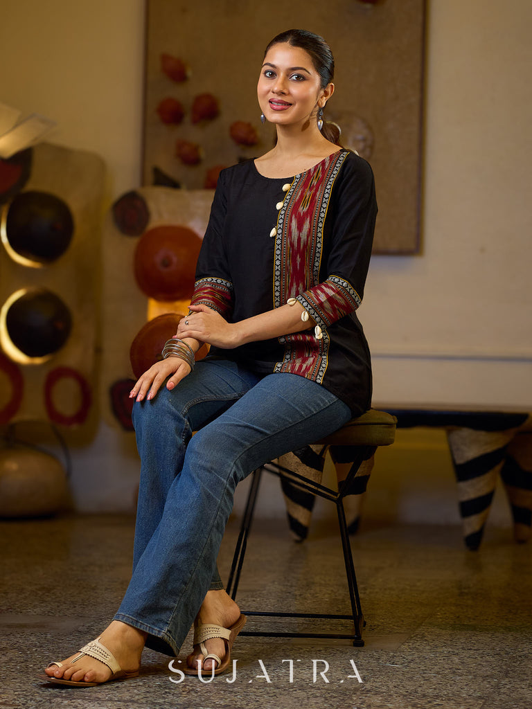 Sleek Black Cotton Silk Top Adorned with Ikat Borders and Exquisite Cowrie Embellishments