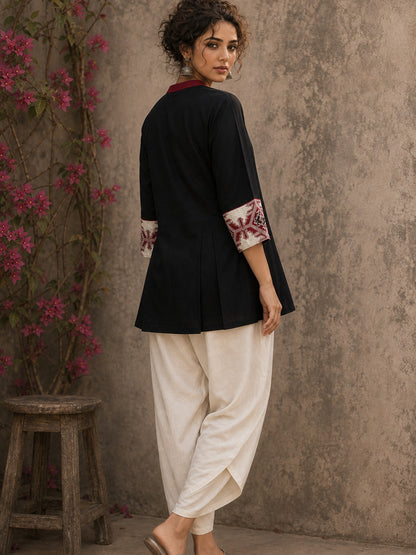 Heritage-inspired black top showcasing handcrafted block print panels, elegant maroon trims, and timeless artistry for versatile modern styling.