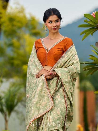 Enchanting Sage Green Saree with All-Over Foil Floral Print & Golden-Orange Trim Detail with Hand Embroidered Pallu