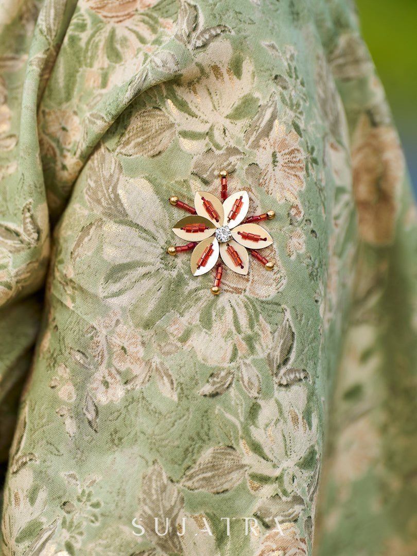Enchanting Sage Green Saree with All-Over Foil Floral Print & Golden-Orange Trim Detail with Hand Embroidered Pallu