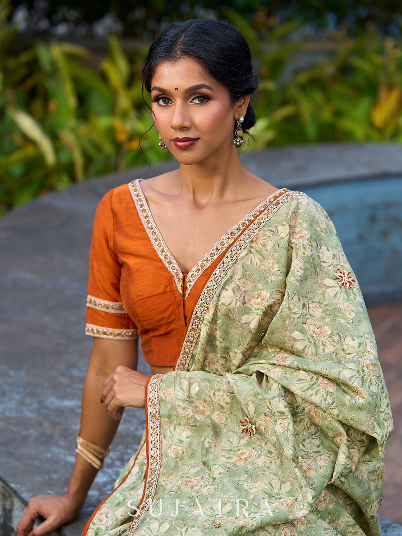 Enchanting Sage Green Saree with All-Over Foil Floral Print & Golden-Orange Trim Detail with Hand Embroidered Pallu