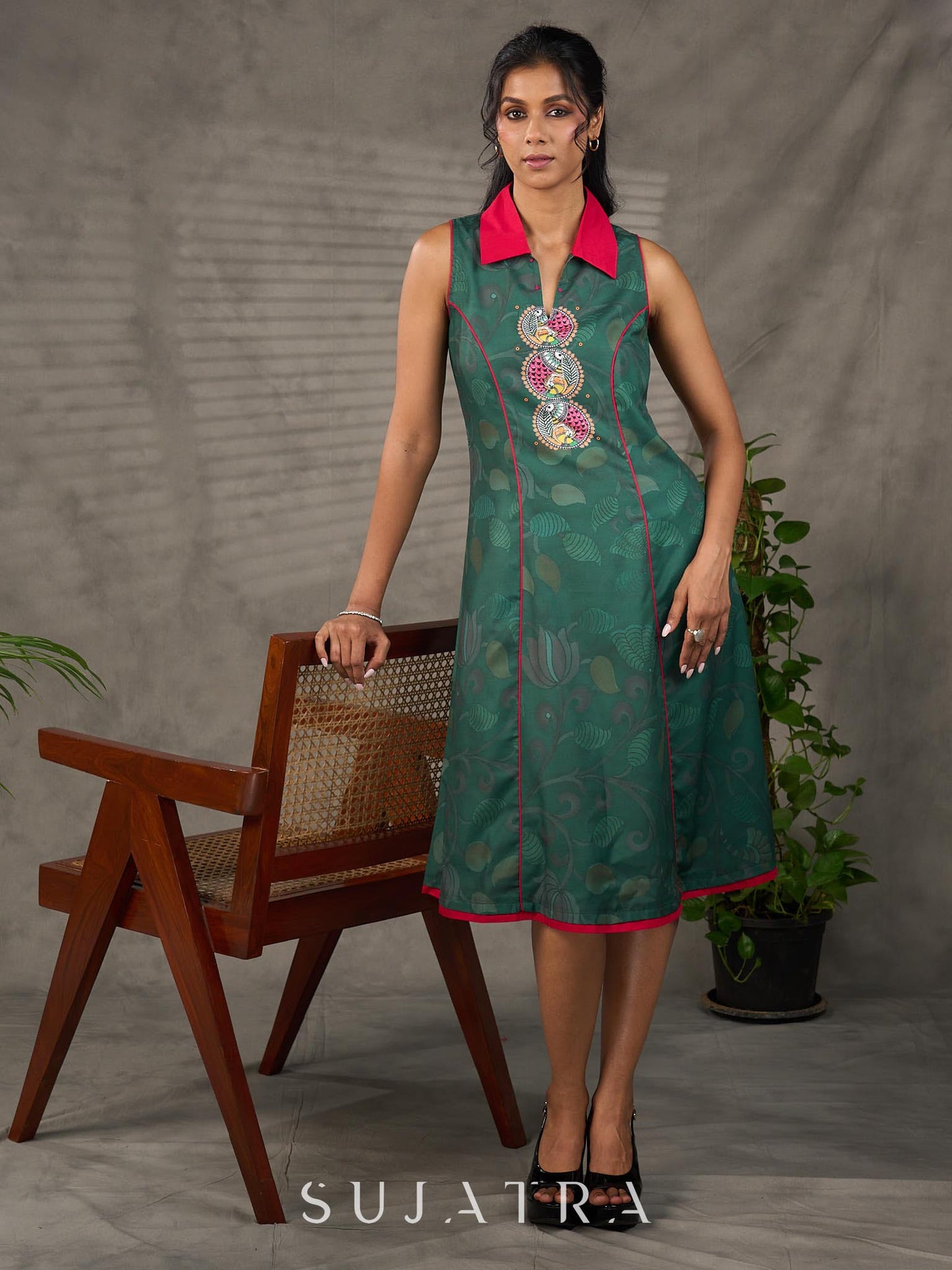 Bottle green Madhubani printed dress with vibrant magenta accents.