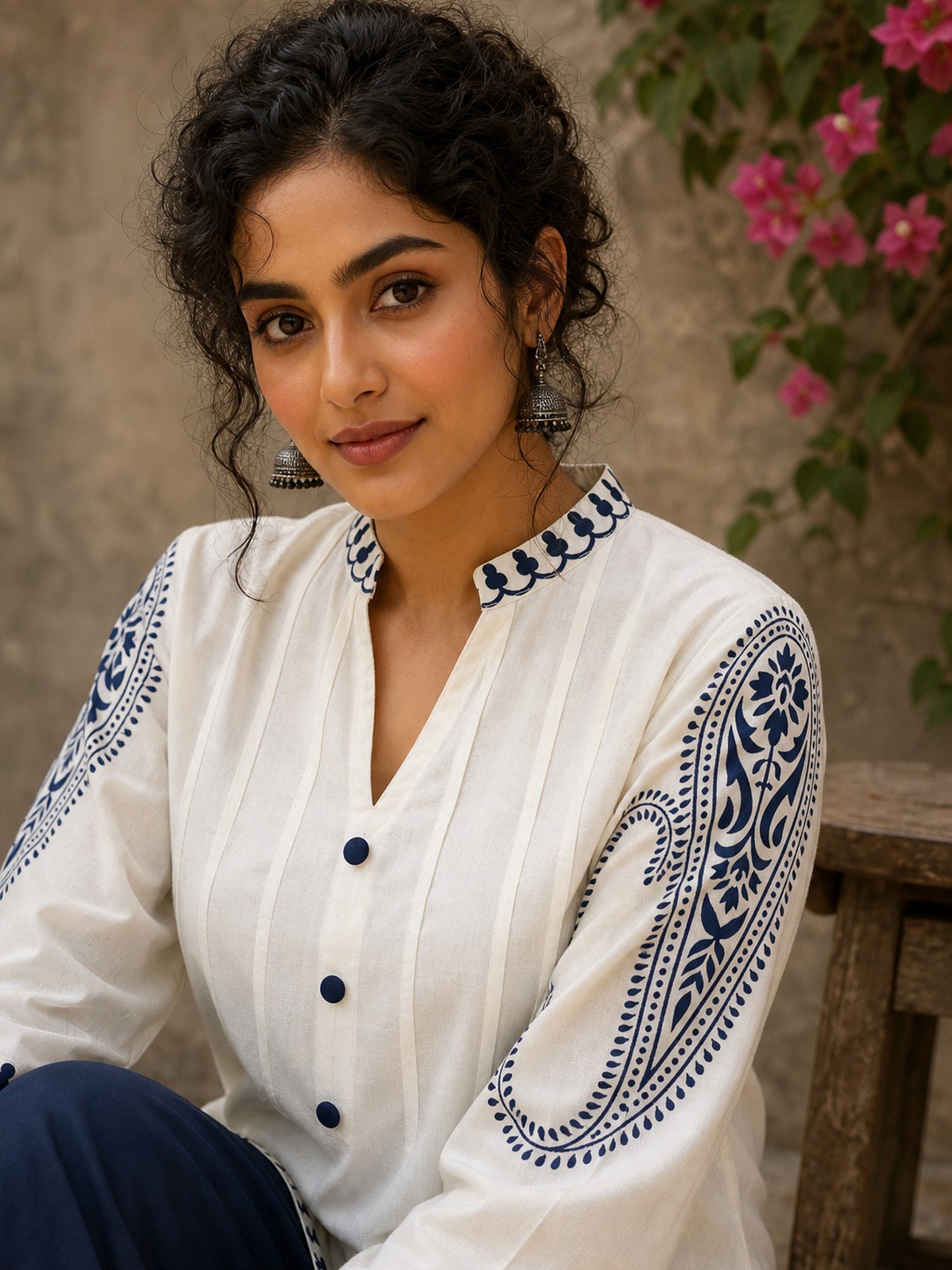Elegant ivory hand block print top featuring intricate navy blue paisley sleeves, refined contrast detailing, and graceful pintucks, blending artisanal craftsmanship with timeless everyday sophistication.