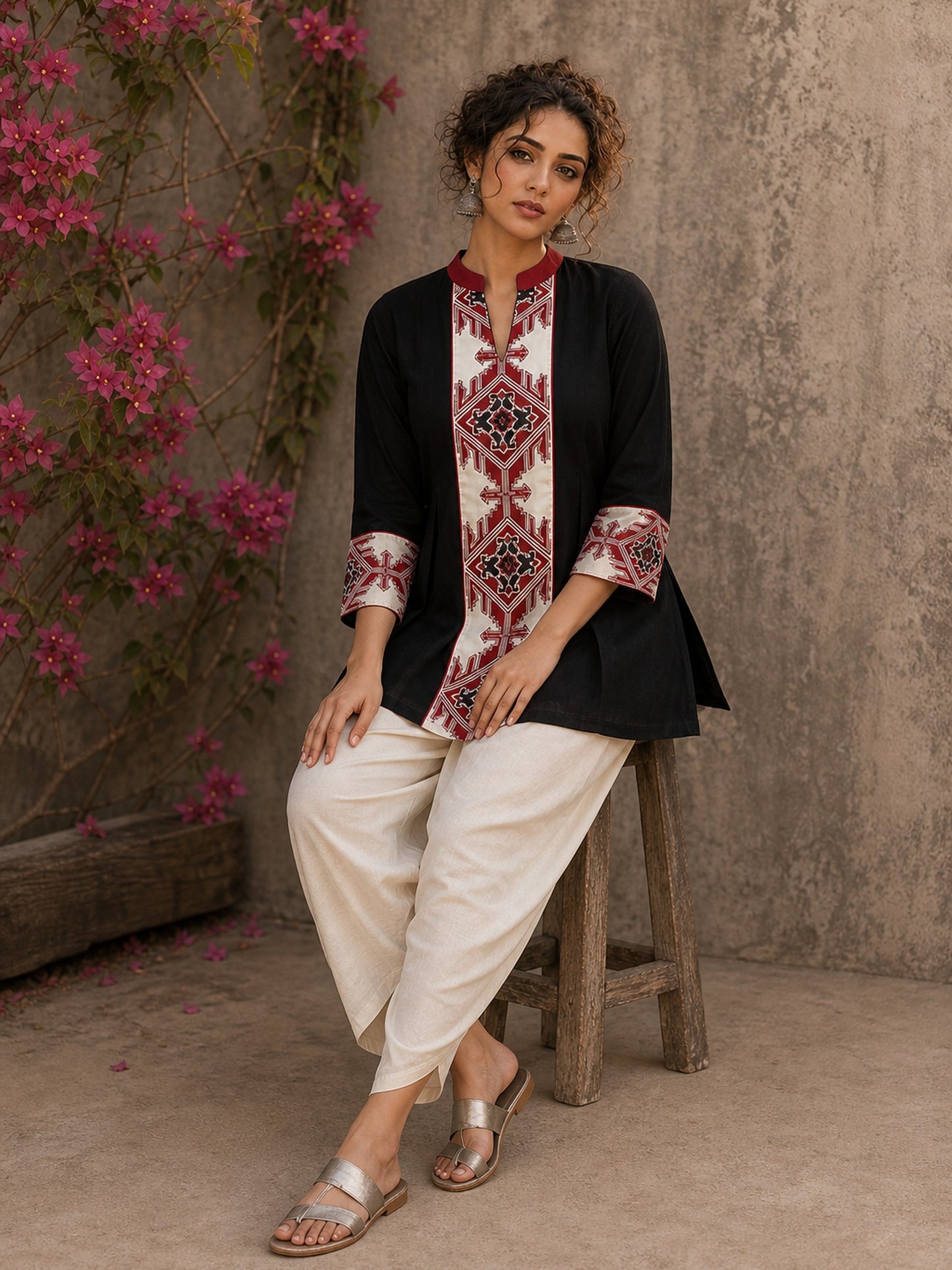Heritage-inspired black top showcasing handcrafted block print panels, elegant maroon trims, and timeless artistry for versatile modern styling.