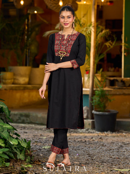 elegant black cotton kurta with beautifully crafted ajrakh panel and subtle stripe piping accents