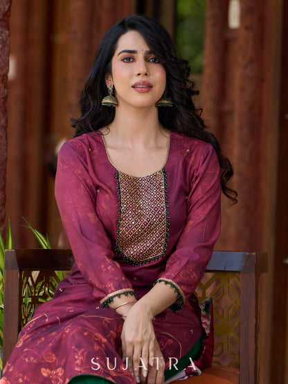 Exquisite deep burgundy printed kurta with intricate neck panel embroidery, delicate green beads, and refined green highlights.