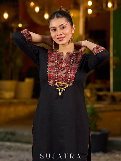 elegant black cotton kurta with beautifully crafted ajrakh panel and subtle stripe piping accents