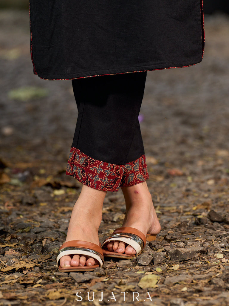 elegant black cotton kurta with beautifully crafted ajrakh panel and subtle stripe piping accents