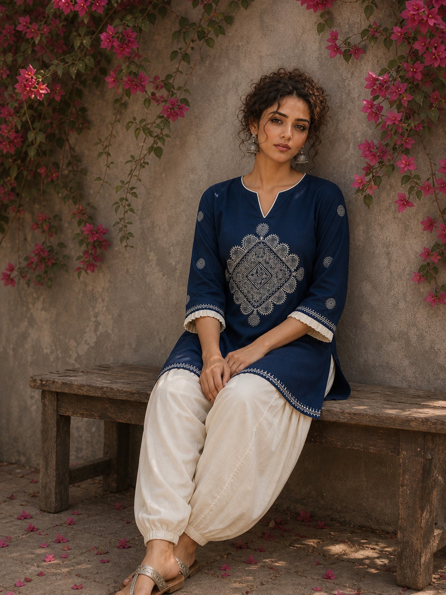 Captivating navy top adorned with a bold, rhythmic block print design, pleated sleeve detailing, and a versatile cut.