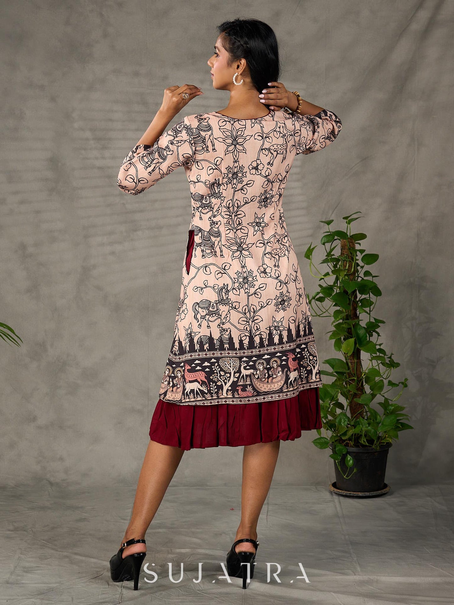 Beige traditional printed dress with rich maroon accents.