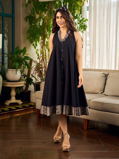 Modern black bias-cut dress showcasing unique artisan-inspired Kalamkari neck trim.