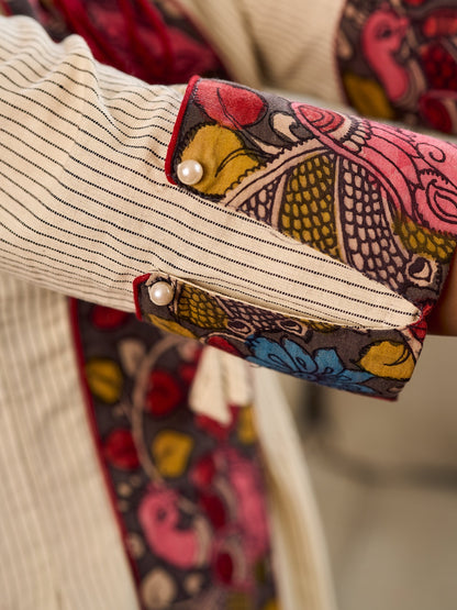White and black striped dress with Kalamkari panel and tie-up neckline.