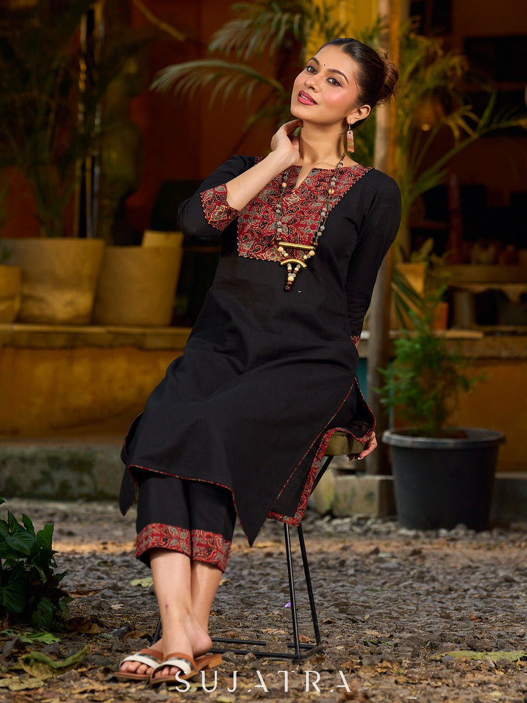 elegant black cotton kurta with beautifully crafted ajrakh panel and subtle stripe piping accents